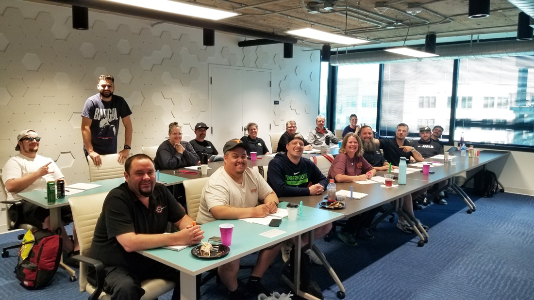Group of people attending a workshop in a modern classroom environment.