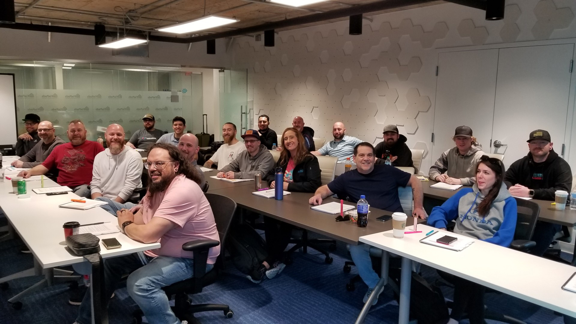 Team in a conference room attending a workshop, engaged and taking notes.