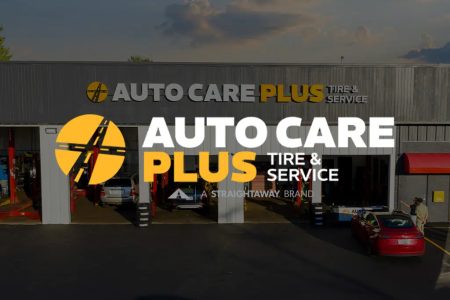 Auto Care Plus Tire & Service center exterior with cars, showcasing automotive maintenance facilities.